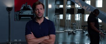 Movie still from “We're the Millers” (2013), directed by Rawson Marshall Thurber – A man standing in a room with his arms crossed; Close Up shot, Over the shoulder angle