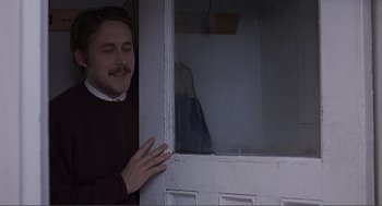 Movie still from “Lars and the Real Girl” (2007), directed by Craig Gillespie – A man leaning against a window with his hand on the window; Medium shot, Over the shoulder angle