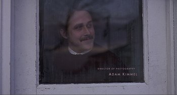 Movie still from “Lars and the Real Girl” (2007), directed by Craig Gillespie – A man with a mustache looking out of a window; Close Up shot, Low angle