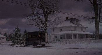 Movie still from “Lars and the Real Girl” (2007), directed by Craig Gillespie – A delivery truck parked on the side of the road in front of a house; Extreme Wide shot, Low angle
