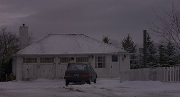 Movie still from “Lars and the Real Girl” (2007), directed by Craig Gillespie – A car parked in front of a house in the snow; Extreme Wide shot, Low angle