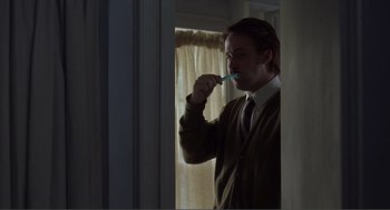Movie still from “Lars and the Real Girl” (2007), directed by Craig Gillespie – A man brushing his teeth with a toothbrush; Medium shot, Over the shoulder angle