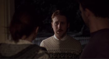 Movie still from “Lars and the Real Girl” (2007), directed by Craig Gillespie – A man wearing a sweater is talking to two women; Medium shot, Over the shoulder angle