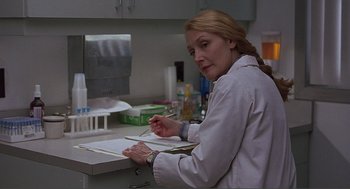 Movie still from “Lars and the Real Girl” (2007), directed by Craig Gillespie – A woman in a lab coat writing on a piece of paper; Close Up shot, Over the shoulder angle