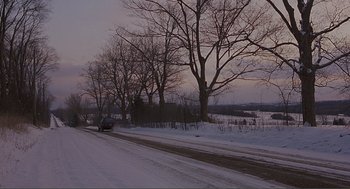 Movie still from “Lars and the Real Girl” (2007), directed by Craig Gillespie – A car driving down a snow covered road; Extreme Wide shot, High angle