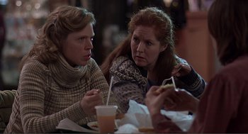 Movie still from “Lars and the Real Girl” (2007), directed by Craig Gillespie – Two women are sitting at a table and one is holding a cell phone; Medium shot, Over the shoulder angle