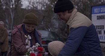 Movie still from “Lars and the Real Girl” (2007), directed by Craig Gillespie – A man and a woman and a little boy holding flowers; Close Up shot, Over the shoulder angle