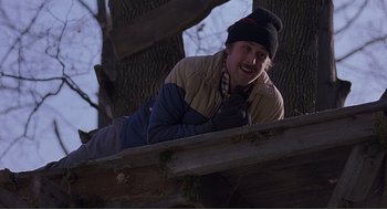 Movie still from “Lars and the Real Girl” (2007), directed by Craig Gillespie – A man laying on the ground next to a tree; Medium shot, Low angle