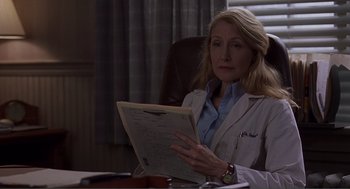 Movie still from “Lars and the Real Girl” (2007), directed by Craig Gillespie – A woman sitting at a desk holding papers; Close Up shot, Over the shoulder angle