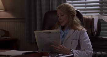 Movie still from “Lars and the Real Girl” (2007), directed by Craig Gillespie – A woman in a white lab coat looking at papers; Close Up shot, Over the shoulder angle
