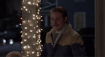 Movie still from “Lars and the Real Girl” (2007), directed by Craig Gillespie – A man with a beard and a mustache standing in front of a christmas tree; Medium shot, Over the shoulder angle