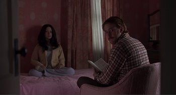 Movie still from “Lars and the Real Girl” (2007), directed by Craig Gillespie – A man and a woman sitting on a bed reading a book; Medium shot, Over the shoulder angle