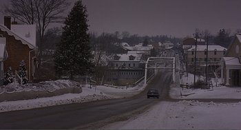 Movie still from “Lars and the Real Girl” (2007), directed by Craig Gillespie – A car driving down a snow covered road; Extreme Wide shot, High angle