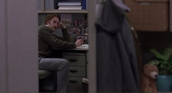 Movie still from “Lars and the Real Girl” (2007), directed by Craig Gillespie – A man sitting at a computer in a room; Medium shot, Over the shoulder angle
