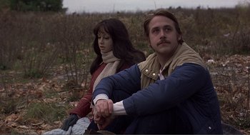 Movie still from “Lars and the Real Girl” (2007), directed by Craig Gillespie – A man and a woman sitting in a field; Medium shot, Over the shoulder angle