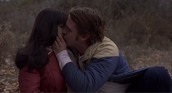Movie still from “Lars and the Real Girl” (2007), directed by Craig Gillespie – A man and a woman kissing in a field; Close Up shot, Over the shoulder angle
