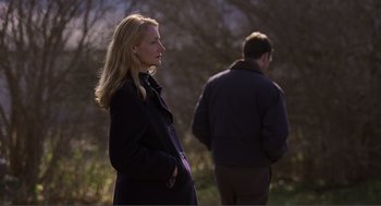 Movie still from “Lars and the Real Girl” (2007), directed by Craig Gillespie – A woman standing next to a man in a field; Medium shot, Over the shoulder angle