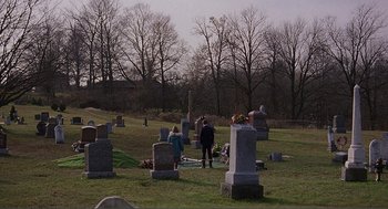 Movie still from “Lars and the Real Girl” (2007), directed by Craig Gillespie – A group of people standing in a field near a cemetery; Extreme Wide shot, Over the shoulder angle