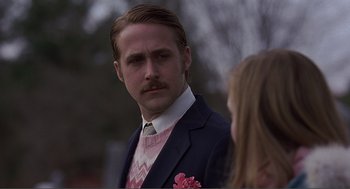 Movie still from “Lars and the Real Girl” (2007), directed by Craig Gillespie – A man in a suit and tie standing next to a woman in a suit; Close Up shot, Over the shoulder angle