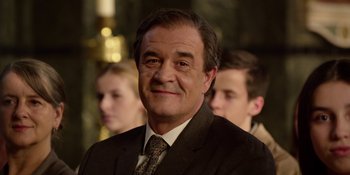 Movie still from “Last Christmas” (2019), directed by Paul Feig – A person wearing a suit and tie; Close Up shot, Over the shoulder angle