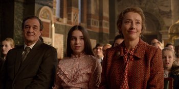Movie still from “Last Christmas” (2019), directed by Paul Feig – Two women and a man are standing in a church; Medium shot, Low angle