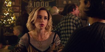 Movie still from “Last Christmas” (2019), directed by Paul Feig – A woman sitting at a table with a glass of wine; Close Up shot, Over the shoulder angle