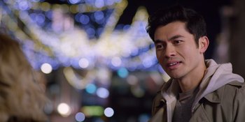 Movie still from “Last Christmas” (2019), directed by Paul Feig – A person wearing a jacket; Close Up shot, Over the shoulder angle