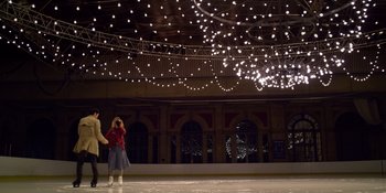 Movie still from “Last Christmas” (2019), directed by Paul Feig – Two people are standing on the ice at night; Extreme Wide shot, High angle