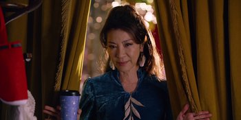 Movie still from “Last Christmas” (2019), directed by Paul Feig – A person standing in front of a curtain; Close Up shot, Over the shoulder angle