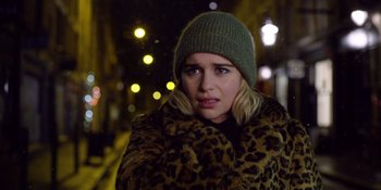 Movie still from “Last Christmas” (2019), directed by Paul Feig – A woman wearing a leopard print coat and a green hat; Close Up shot, Over the shoulder angle