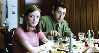 Movie still from “Last Night” (1998), directed by Don McKellar – A man and a woman sitting at a table with plates of food; Medium shot, Over the shoulder angle