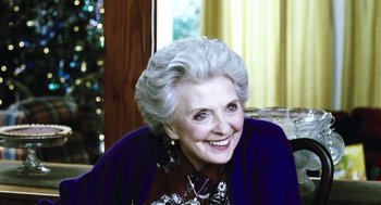 Movie still from “Last Night” (1998), directed by Don McKellar – An older woman with white hair sitting in front of a christmas tree; Close Up shot, Over the shoulder angle