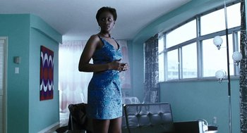 Movie still from “Last Night” (1998), directed by Don McKellar – A woman in a blue dress standing in front of a window; Medium shot, Low angle