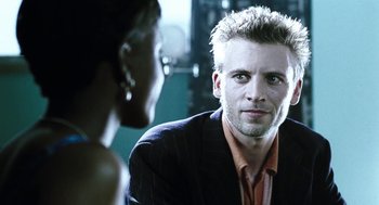 Movie still from “Last Night” (1998), directed by Don McKellar – A man and a woman are looking at one another in the mirror; Close Up shot, Over the shoulder angle