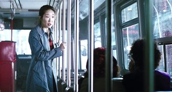 Movie still from “Last Night” (1998), directed by Don McKellar – A woman standing on a train looking out of a window; Medium shot, Over the shoulder angle