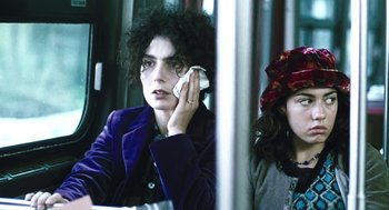 Movie still from “Last Night” (1998), directed by Don McKellar – A woman holding a cell phone up to her ear; Close Up shot, Over the shoulder angle