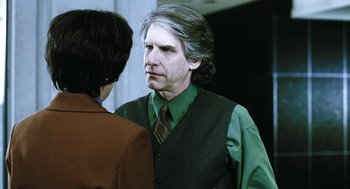 Movie still from “Last Night” (1998), directed by Don McKellar – A man in a green shirt and a woman in a brown tie; Close Up shot, Over the shoulder angle