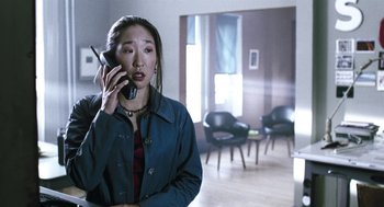Movie still from “Last Night” (1998), directed by Don McKellar – A woman talking on a cell phone while wearing a blue jacket; Medium shot, Low angle