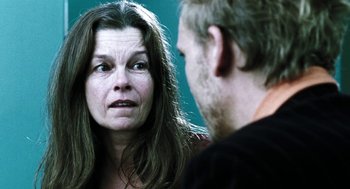 Movie still from “Last Night” (1998), directed by Don McKellar – A man and a woman are talking to each other; Close Up shot, Over the shoulder angle