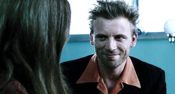 Movie still from “Last Night” (1998), directed by Don McKellar – A person wearing a jacket; Close Up shot, Over the shoulder angle