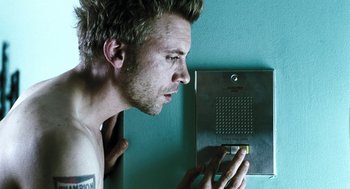 Movie still from “Last Night” (1998), directed by Don McKellar – A person holding a cell phone; Close Up shot, Low angle