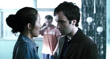 Movie still from “Last Night” (1998), directed by Don McKellar – A man and a woman talking to each other; Close Up shot, Over the shoulder angle