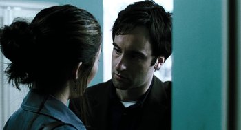 Movie still from “Last Night” (1998), directed by Don McKellar – A man and a woman looking at each other in a mirror; Close Up shot, Over the shoulder angle