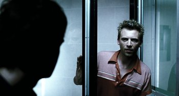 Movie still from “Last Night” (1998), directed by Don McKellar – A man standing in front of a bathroom mirror; Close Up shot, Over the shoulder angle