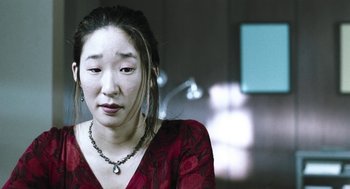 Movie still from “Last Night” (1998), directed by Don McKellar – A person wearing a necklace; Close Up shot, Over the shoulder angle