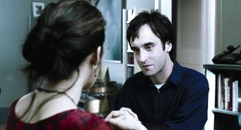 Movie still from “Last Night” (1998), directed by Don McKellar – A man and a woman looking at one another in the mirror; Close Up shot, Over the shoulder angle