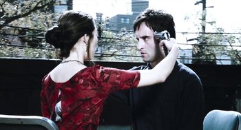 Movie still from “Last Night” (1998), directed by Don McKellar – A man and a woman are looking at each other; Close Up shot, Over the shoulder angle