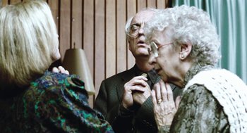 Movie still from “Last Night” (1998), directed by Don McKellar – An older man and a younger woman talking to each other; Close Up shot, Low angle