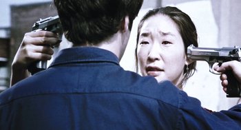 Movie still from “Last Night” (1998), directed by Don McKellar – A man and a woman looking at one another; Close Up shot, Over the shoulder angle