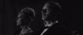 Movie still from “Last Year at Marienbad” (1961), directed by Alain Resnais – A black and white photo of a man and a woman; Close Up shot, Low angle